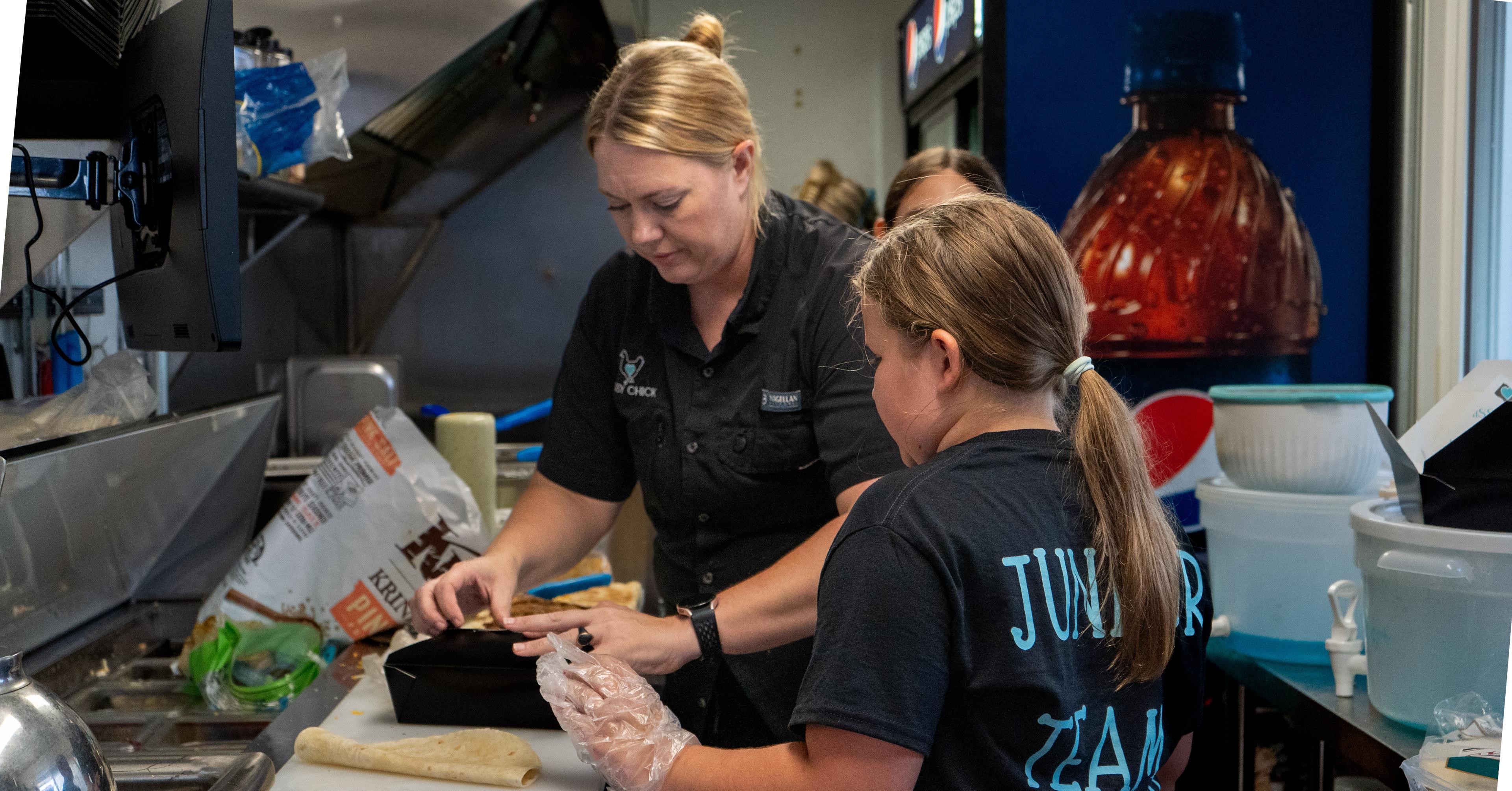 Hissy Chick instructor teaching a camper hands-on kitchen skills